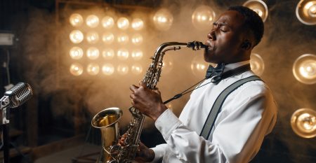 Black jazz performer plays the saxophone on stage